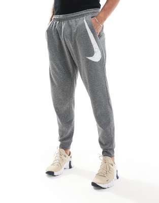 Nike Training Nike Training Swoosh graphic tapered joggers in grey-Black