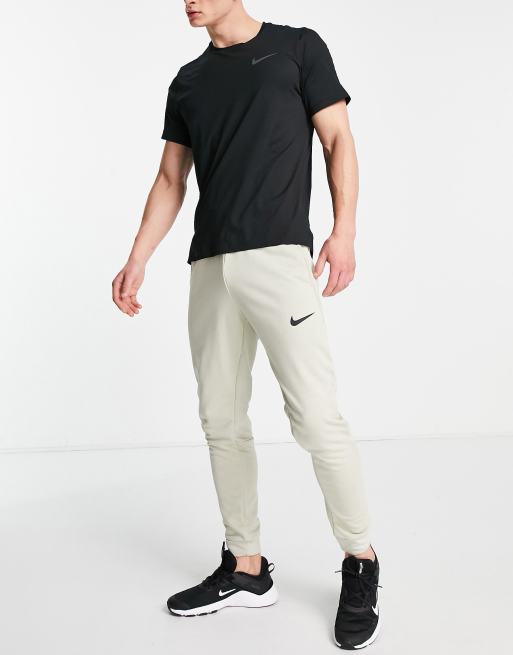 Nike Training tapered fleece joggers in stone ASOS