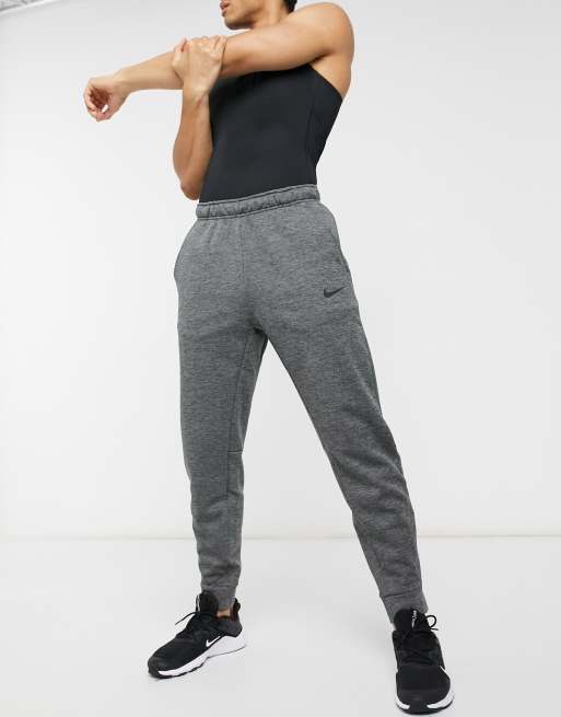 Nike training fleece tapered joggers best sale in dark grey