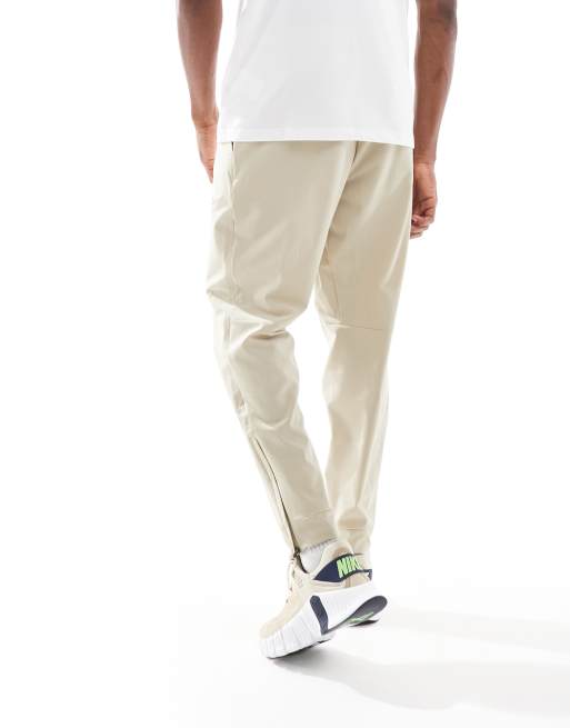 Nike Training Unlimited Dri-FIT track trouser in beige ASOS