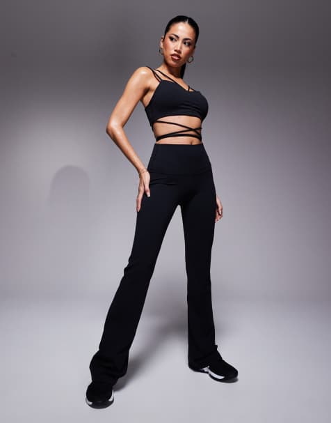 Nike Training Zenvy Yoga strappy wrap light support sports bra and Yoga high waisted flared leggings in black - view 1