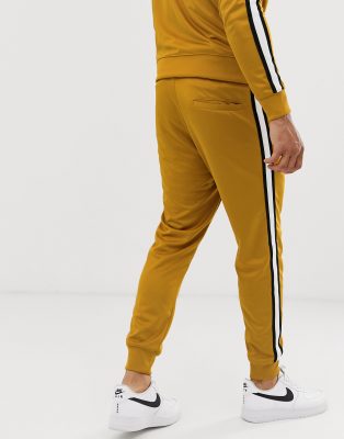 pantaloni nike uomo oro