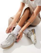 New Balance 1906 sneakers in white with blue and pink details
