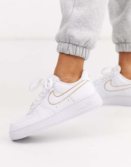 Nike white and gold Air Force 1 07 trainers