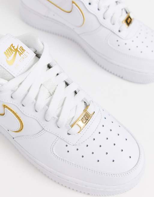 Nike white and gold Air Force 1 07 trainers