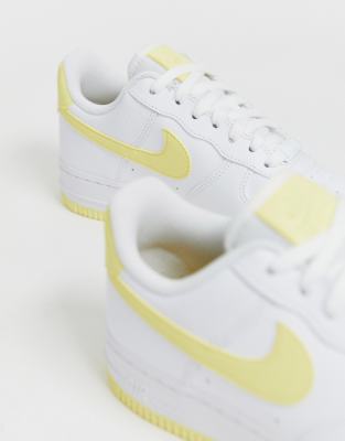 white nike air force with yellow tick