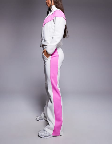 Nike – Windrunner – Polyknit-Trainingshose in Weiß und Rosa mit mittelhohem Bund - view 1