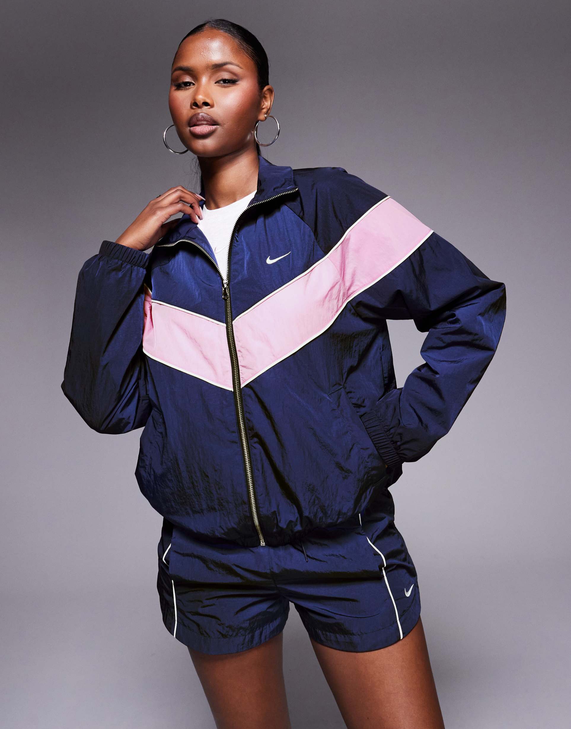 nike windrunner woven track jacket in navy and pink
