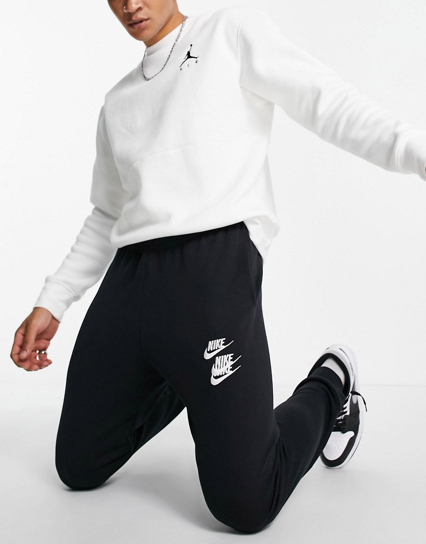 NIKE WORLD TOUR PACK GRAPHIC CUFFED SWEATPANTS IN BLACK,DD0884-010