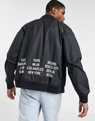 Nike World Tour Pack graphic woven bomber jacket in black | ASOS
