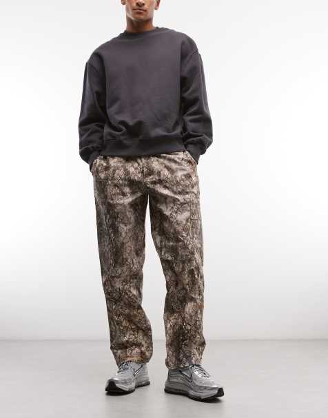 Nike woven trousers in khaki camo print 