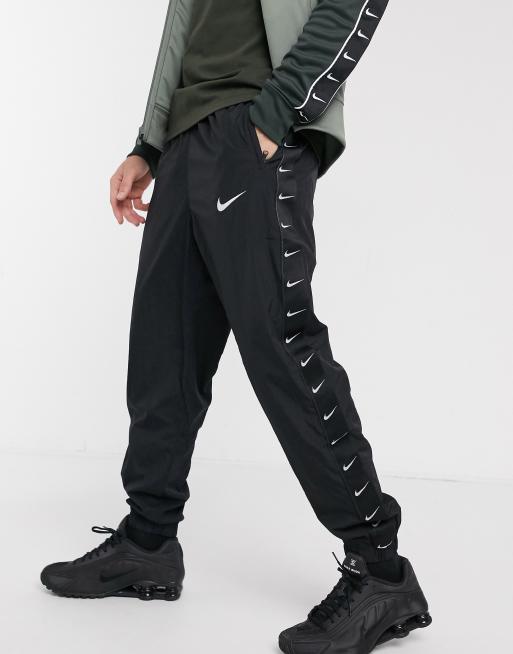 Nike woven taping cuffed joggers in black ASOS