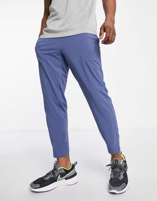 Nike - Yoga Flex - Toelopende joggingbroek in blauw