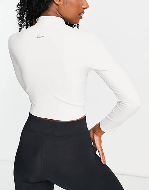 Nike Yoga Luxe Dri-FIT cropped long sleeve top in off white