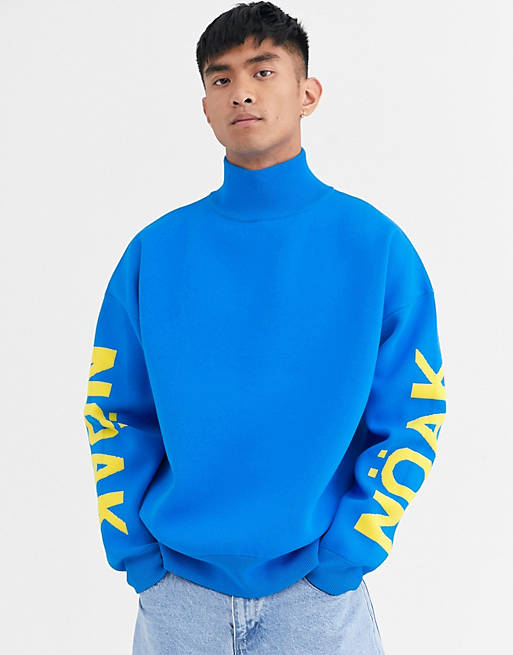 Noak high neck jumper in blue with branded sleeve