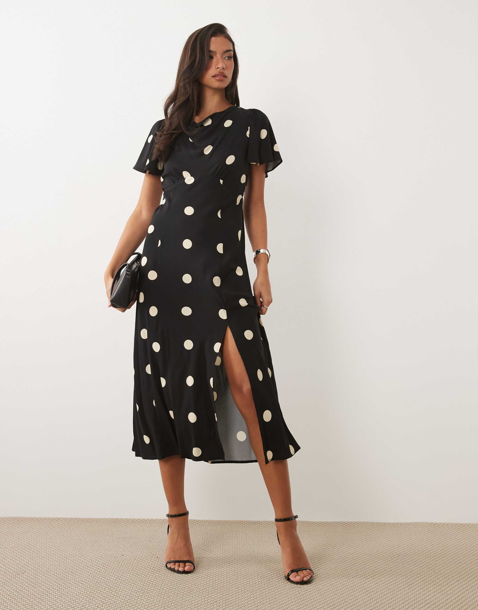 nobody's child cheryl cowl neck flutter sleeve slit front midi dress in oversized black polka dot