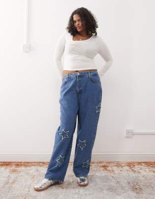 wide leg jeans with star patches in mid wash blue