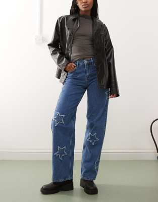 wide leg jeans with star patches in mid wash blue