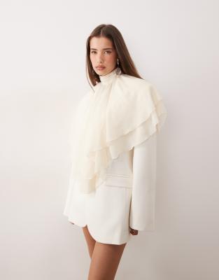 Noughts & Kisses Noughts & Kisses chiffon ruffle high neck poncho blouse in cream-Neutral