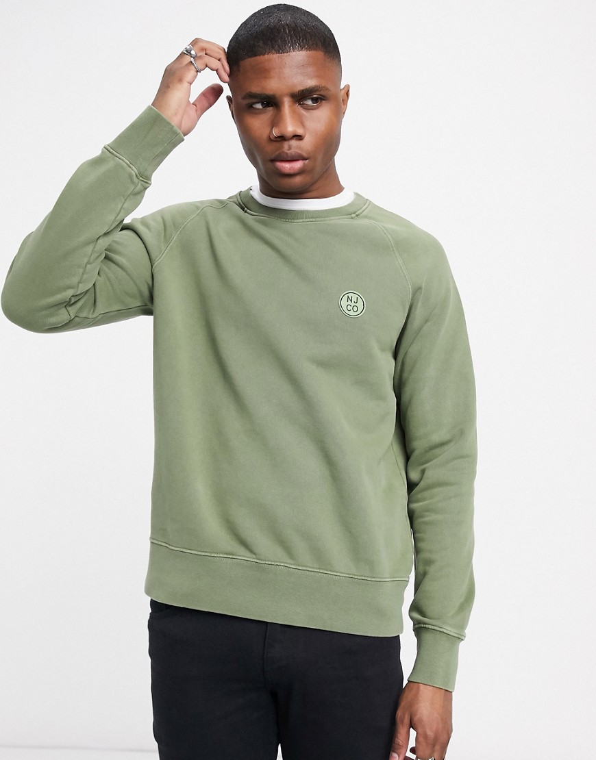 Nudie Jeans Co - Melvin - Sweater met ronde hals en rond logo in groen