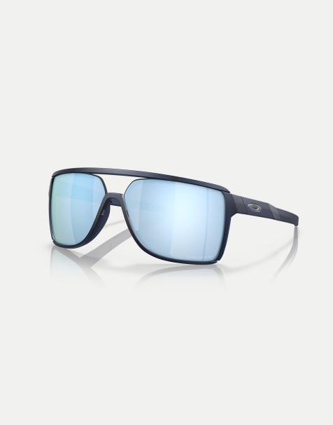 Oakley – Castel – Rechteckige, polarisierte Sonnenbrille in Blau mit verspiegelten Gläsern in matt schimmerndem Blau - view 1