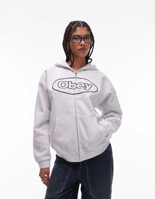 Obey – Jasnoszara zapinana na zamek bluza z kapturem z bardzo grubego materiału z owalnym logo