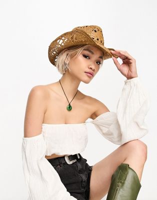 Object straw cowboy hat with black tie detail in neutral