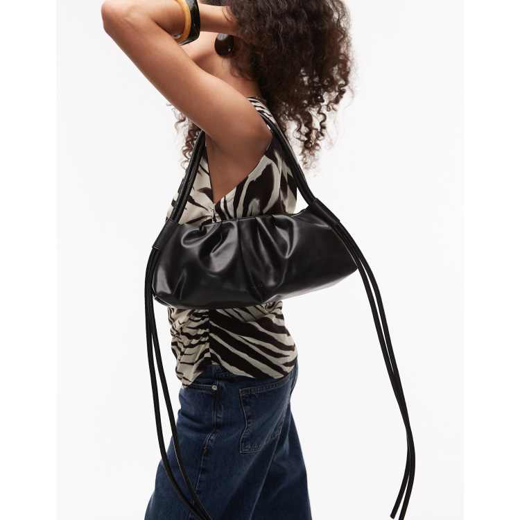 OLEND Dumpling elongated shoulder bag in black | ASOS