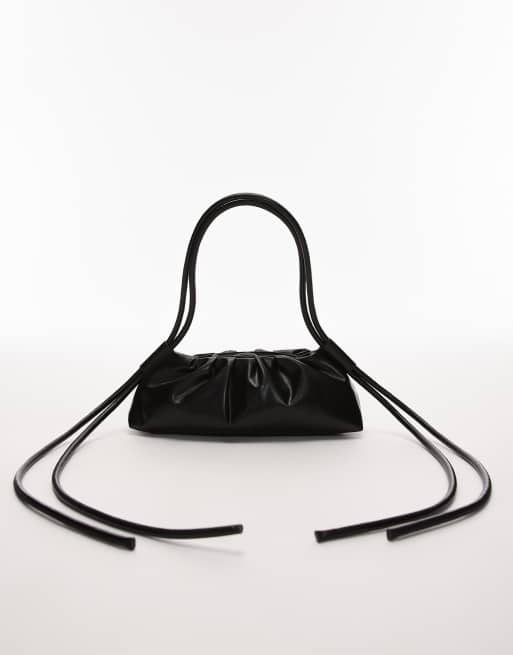 OLEND Dumpling elongated shoulder bag in black | ASOS