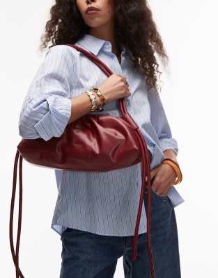 OLEND dumpling elongated shoulder bag in cherry red | ASOS