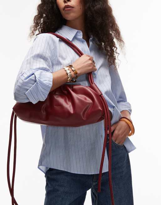 OLEND dumpling leather elongated shoulder bag in cherry red