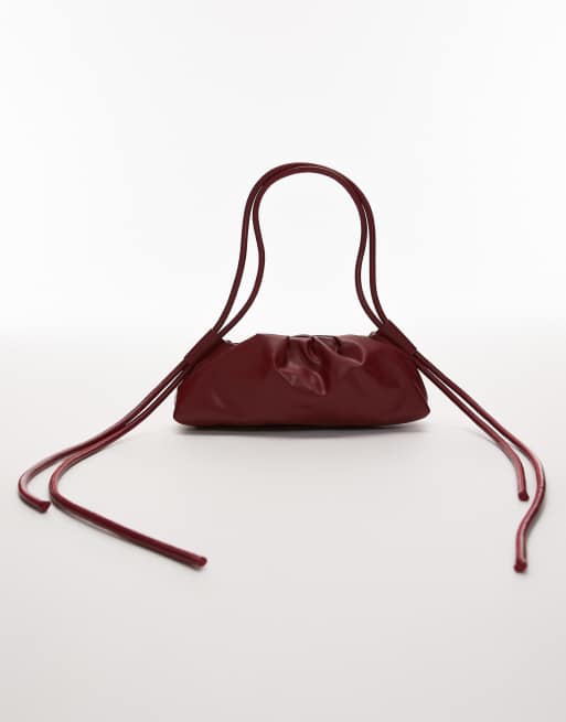 OLEND dumpling leather elongated shoulder bag in cherry red
