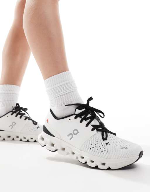 ON Cloud X 4 training trainers in white and black