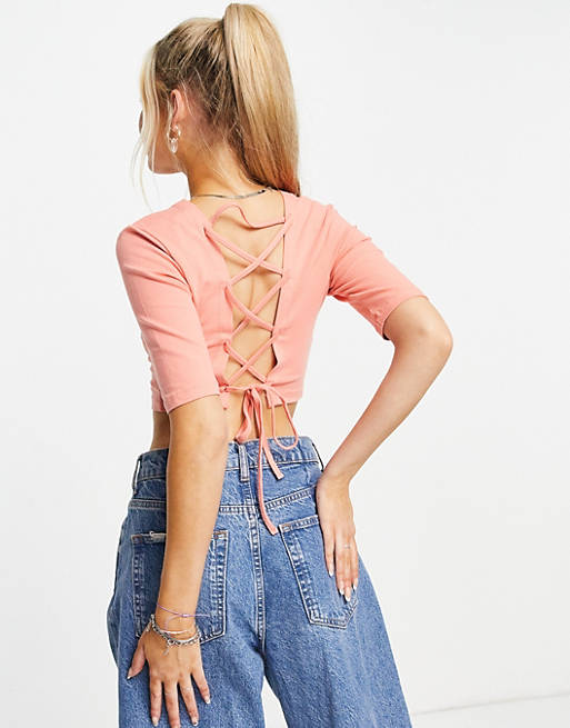 Only cropped jersey top with cut out lace up back in coral