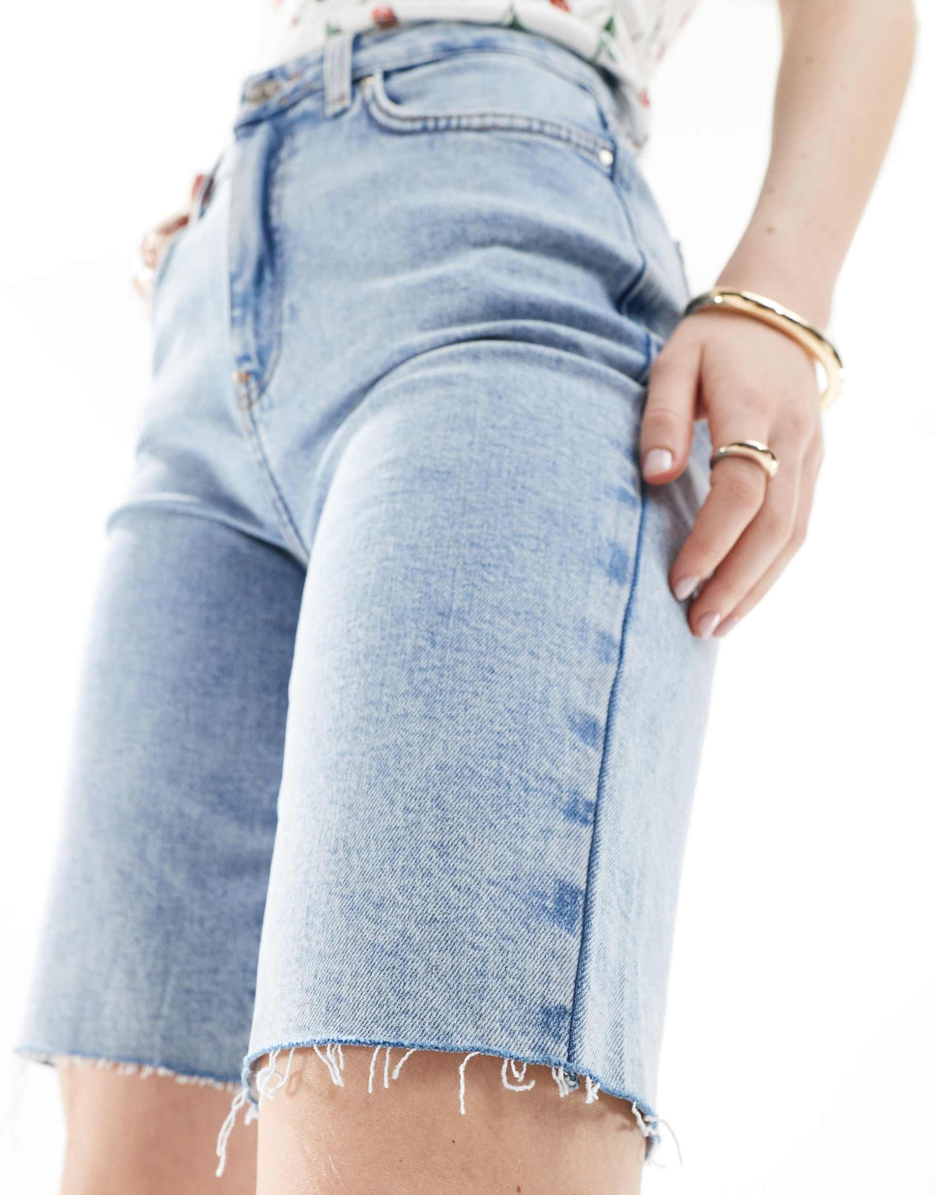 only emily mid raise raw hem longline denim shorts in light blue wash