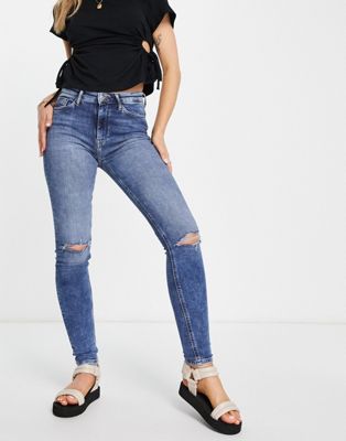 Only high rise skinny jean with distressed knees in medium wash