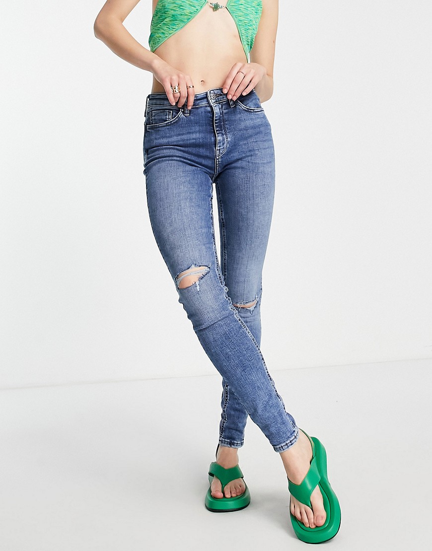 Only high rise skinny jean with distressing in mid blue
