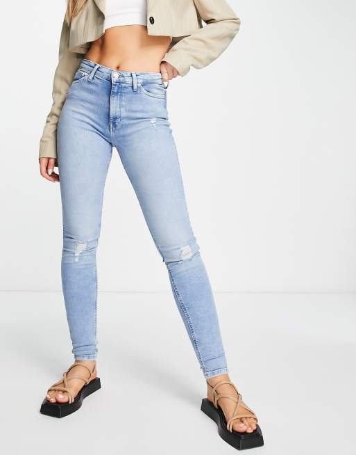 Only high rise skinny jeans with distressed knees in light wash