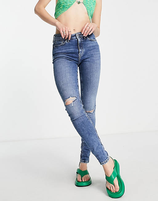 Only high rise skinny jeans with distressing in mid blue