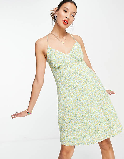 Only mini sundress with cross back in ditsy green floral