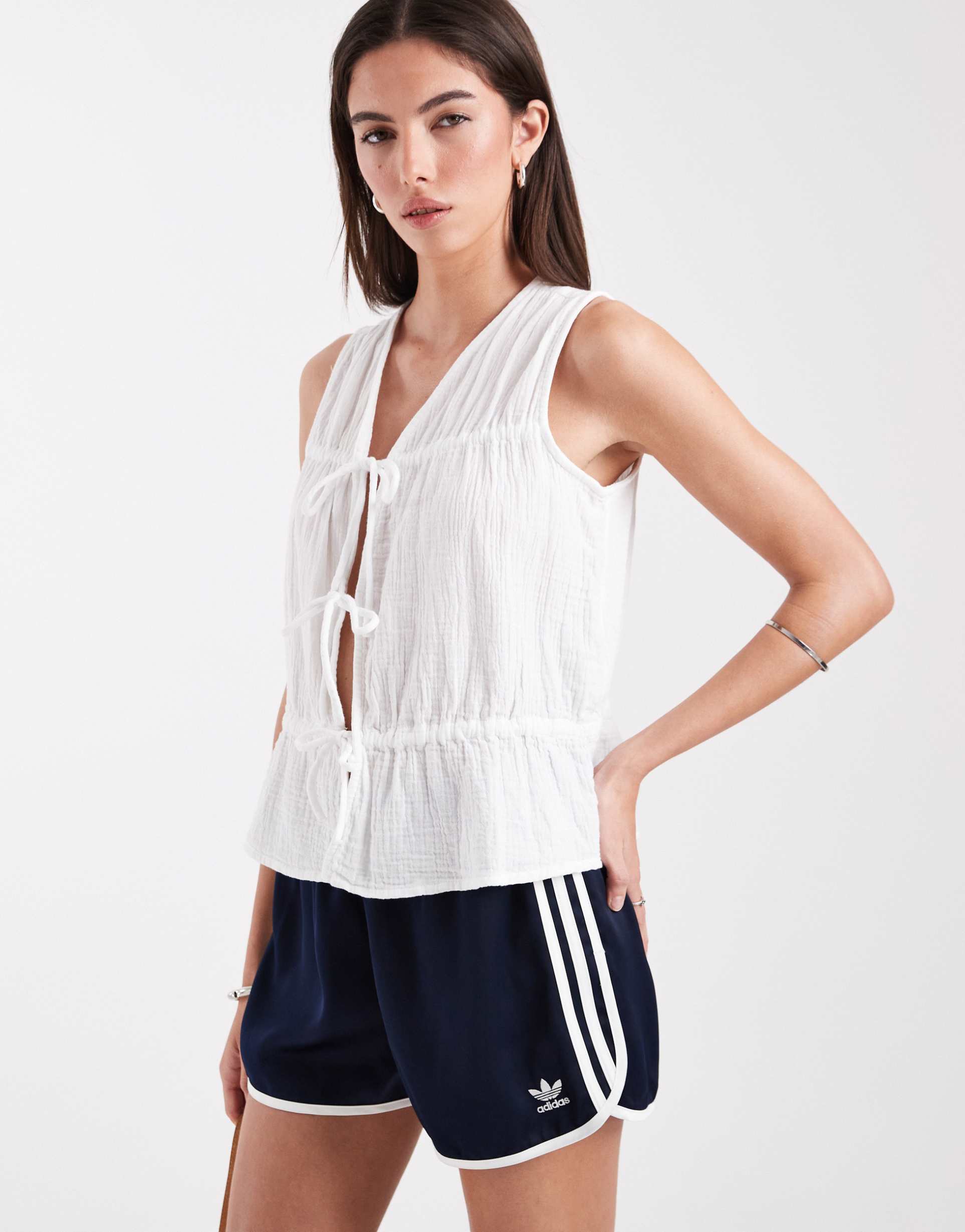 only sleeveless v-neck cheesecloth peplum top with tie front in white