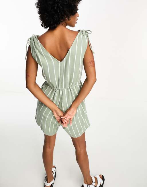 Green and white store romper