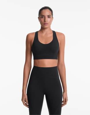 Oysho - Brassière de compression à maintien intermédiaire avec bonnets - Noir