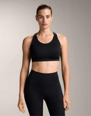 Oysho - Brassière de compression maintien renforcé avec bretelles croisées dans le dos - Noir