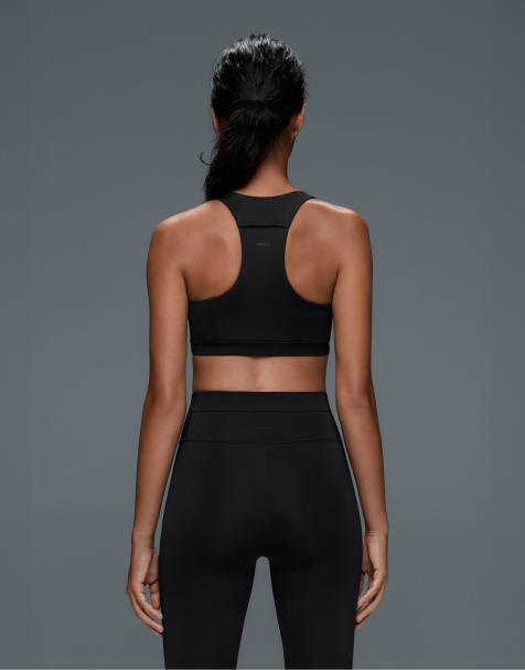 OYSHO brassière de sport à maintien moyen à séchage rapide avec poches en noir - view 1