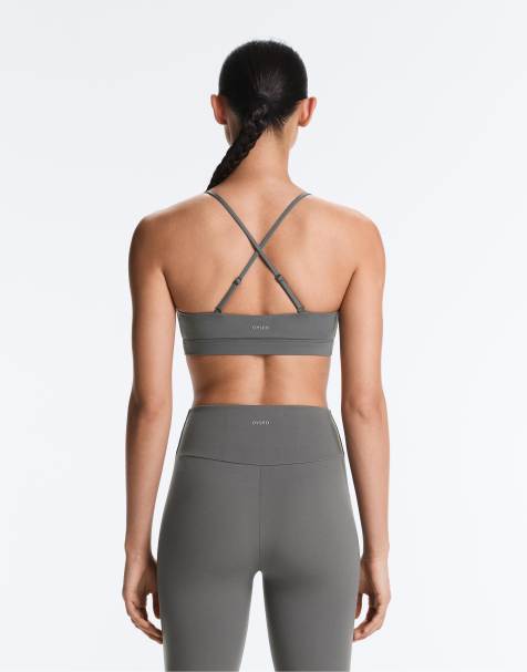 OYSHO brassière de sport Comfortlux à maintien léger avec bretelles croisées gris clair - view 1