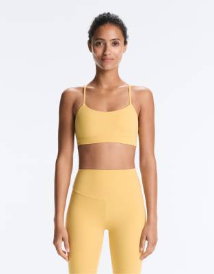 OYSHO Comfortlux light-support sports bra with crossover straps in yellow and green