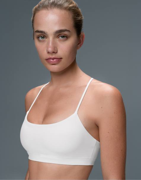 OYSHO - Comfortlux - Reggiseno sportivo a sostegno leggero bianco sporco con spalline incrociate - view 1