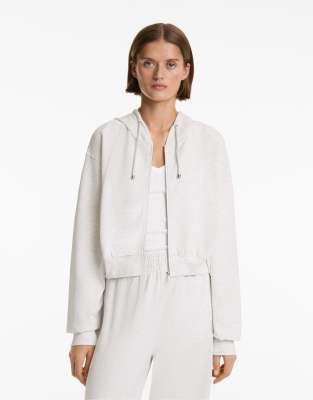 Oysho - Cropped-Kapuzenjacke aus Baumwolle und Modal in Blassgrau meliert mit geripptem Detail