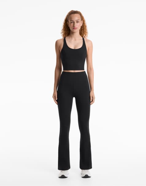 OYSHO Evermove high rise flare trousers in black